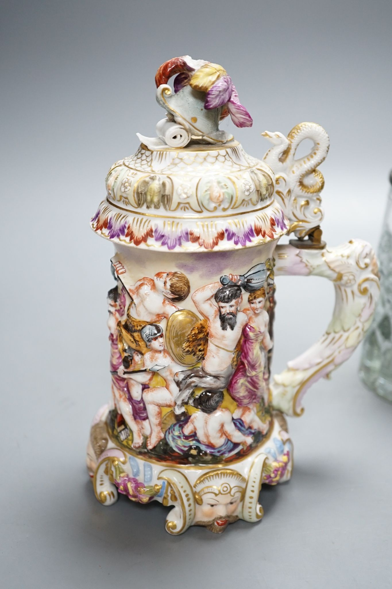 An Italian porcelain lidded tankard and matching jug, together with a cut glass lidded tankard with porcelain inset pewter lid, 22cm